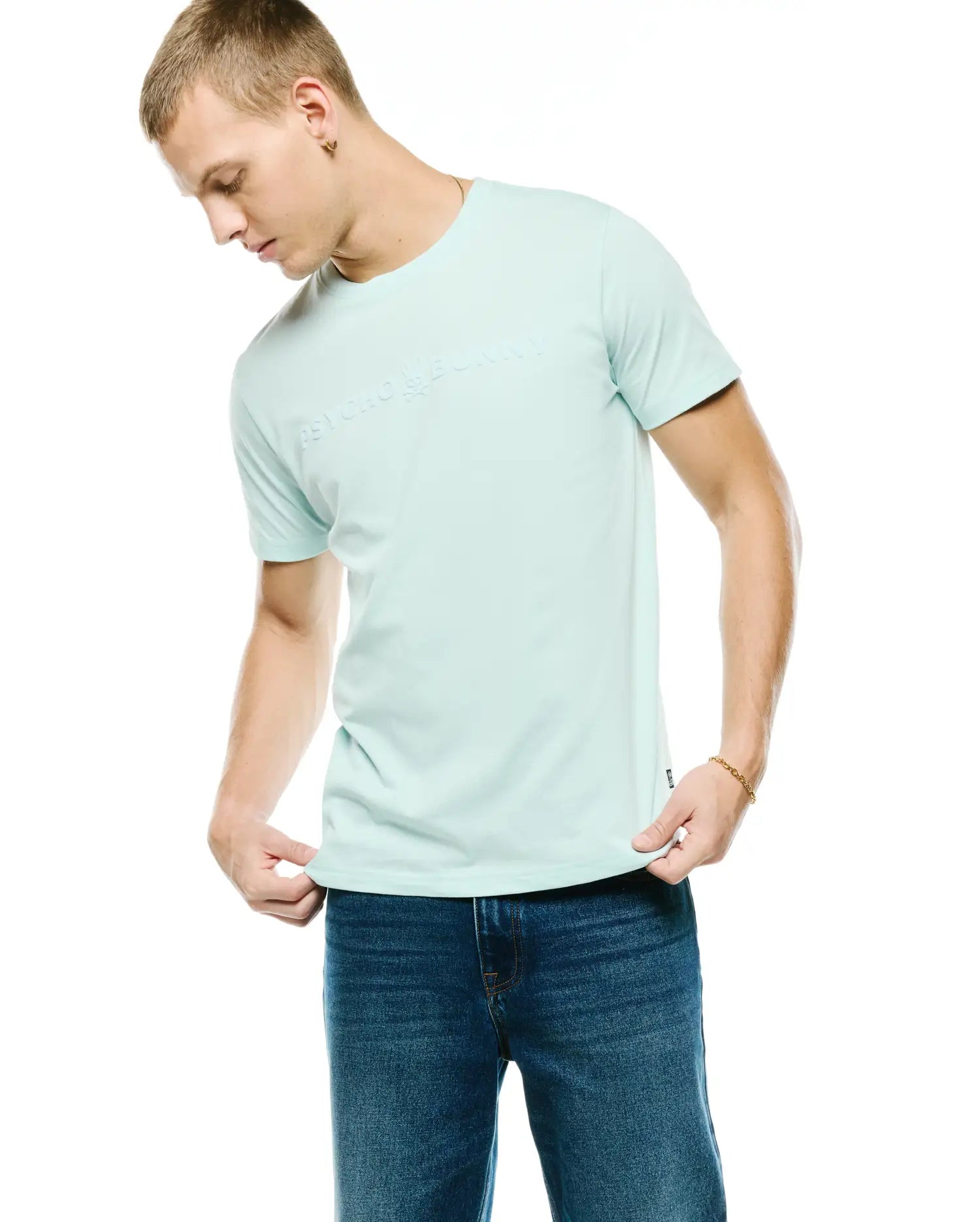 Men's Royce Graphic Tee, light mint green classic fit jersey t-shirt with a large tonal embossed PSYCHO BUNNY text logo across the chest and a small black hem tag. (2)