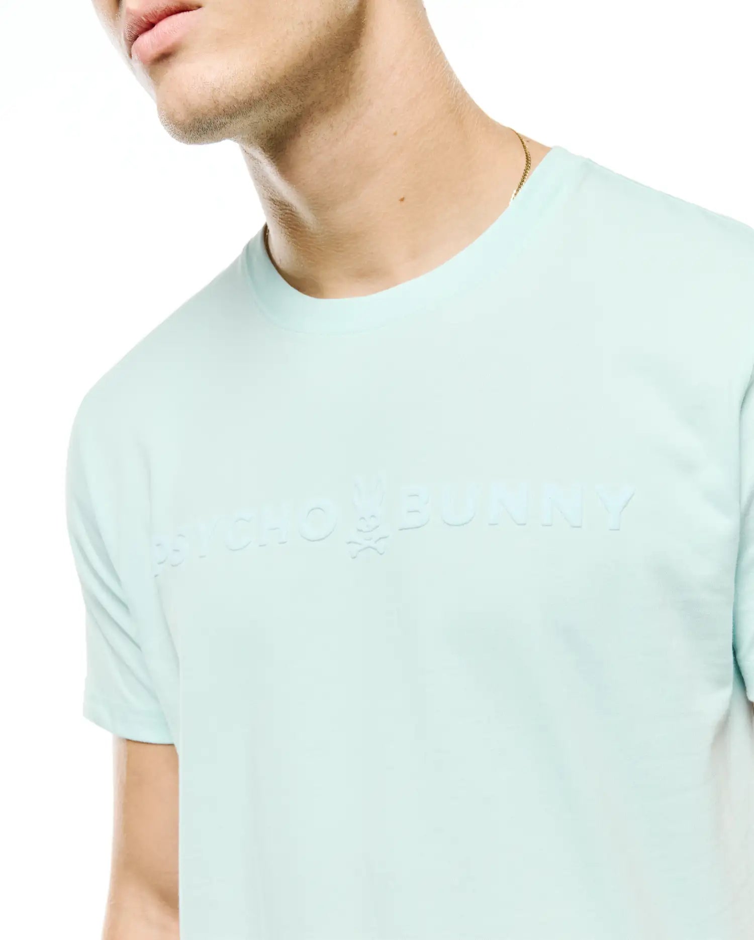 Men's Royce Graphic Tee, a light aqua classic fit jersey t-shirt with a large, tonal embossed Psycho Bunny text logo and iconic bunny skull on the chest. (3)
