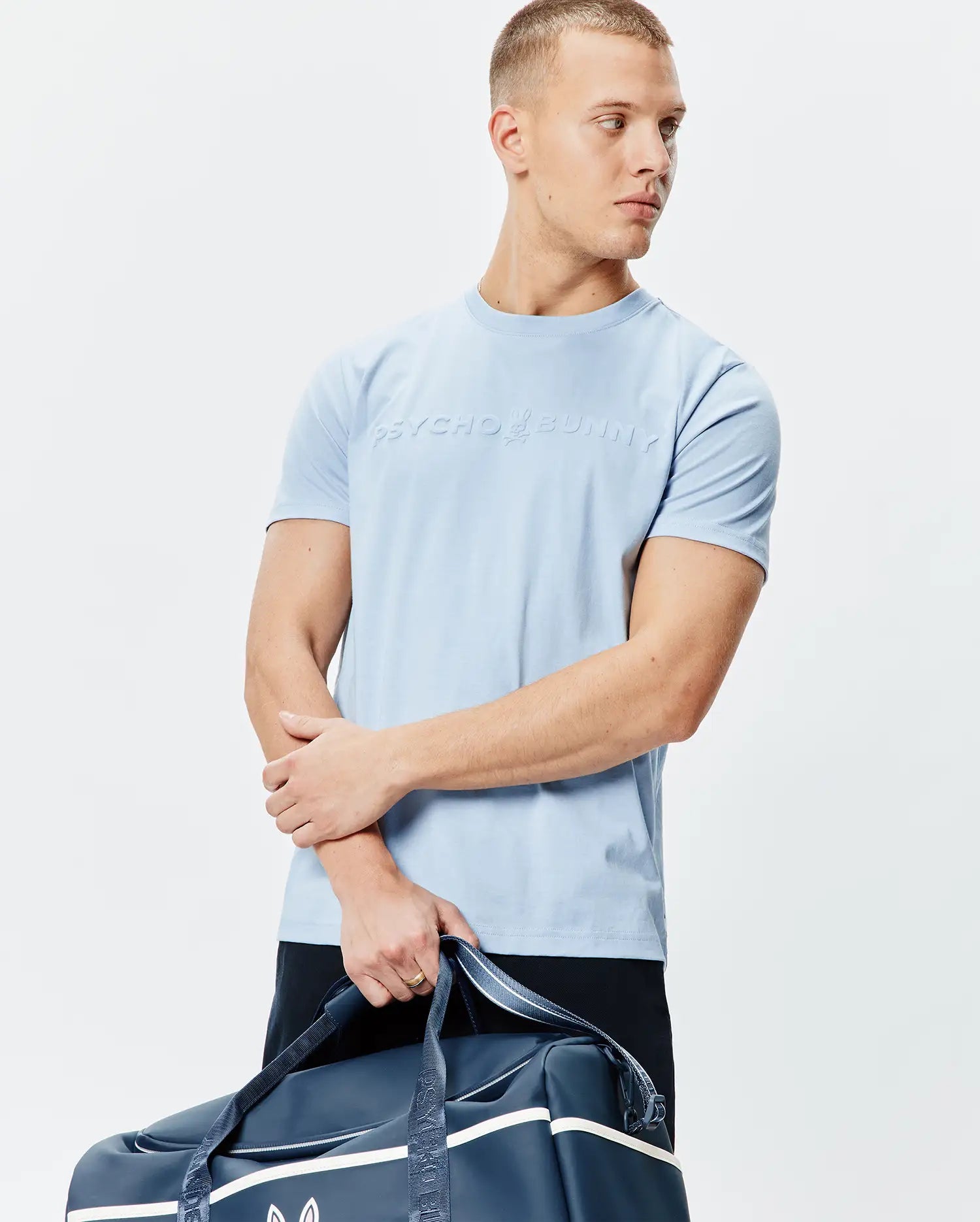 Mens Royce Graphic Tee, sky blue classic fit jersey knit t-shirt featuring a large, raised Psycho Bunny bunny skull logo and text centered on the chest.