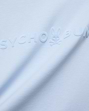 Mens Royce Graphic Tee, light blue jersey knit, featuring a large, tonal, raised velvety Psycho Bunny text logo with the iconic bunny skull on the chest.