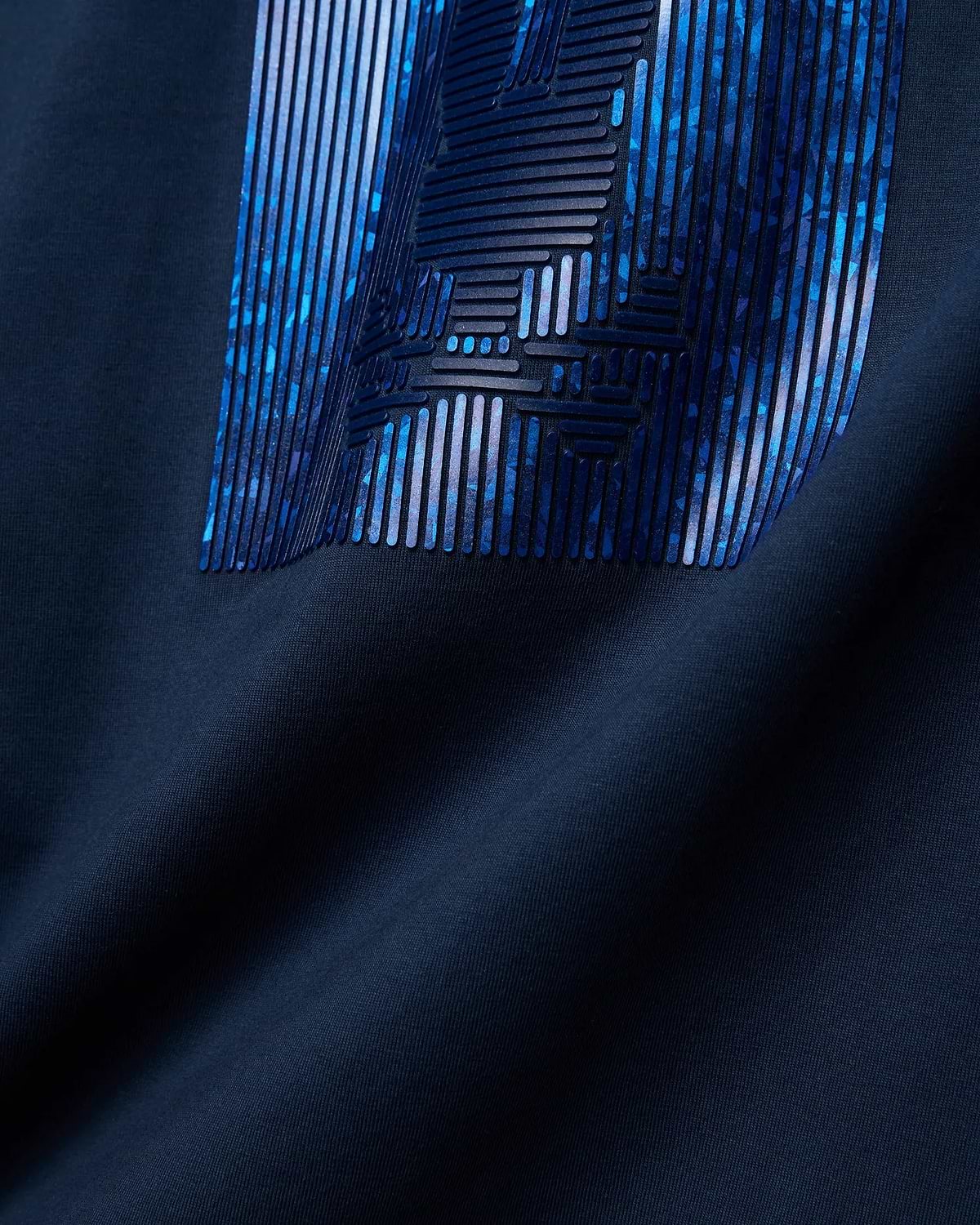 Mens Seamus Graphic Tee in classic navy jersey knit, showcasing a bold, large Psycho Bunny graphic print on the chest with raised dark blue lines over an abstract blue and purple pattern.