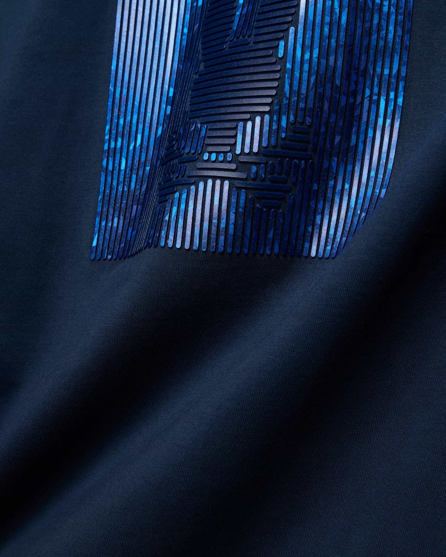 Mens Seamus Graphic Tee in classic navy jersey knit, showcasing a bold, large Psycho Bunny graphic print on the chest with raised dark blue lines over an abstract blue and purple pattern.