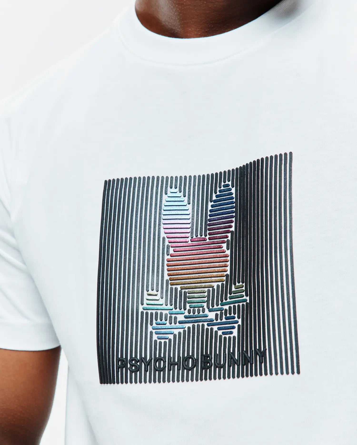 Mens Langston Graphic Tee, a white classic fit jersey t-shirt with a large central graphic featuring a black vertical striped background and a multicolored iridescent Psycho Bunny skull logo and brand name.