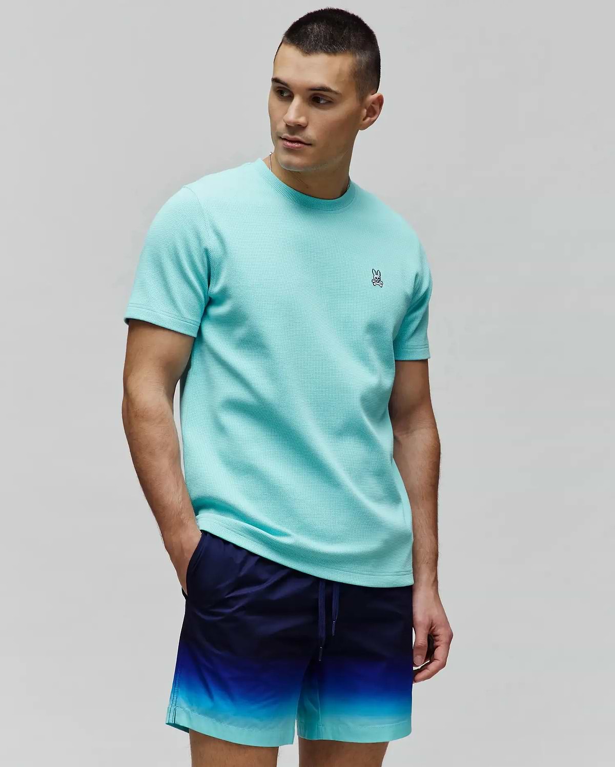 Mens Maxton Waffle Tee in aqua, featuring a classic fit and textured waffle knit fabric with a small, embroidered Psycho Bunny skull logo on the left chest.