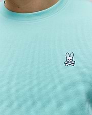 Mens Maxton Waffle Tee in aqua, featuring a classic fit and textured waffle knit fabric, with a small embroidered white, black, and blue Psycho Bunny skull logo on the left chest.