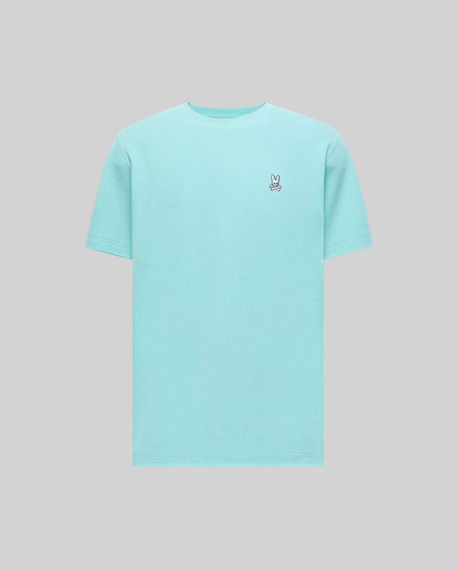 Mens Maxton Waffle Tee in aqua blue, featuring a classic fit and a textured waffle knit fabric. Small embroidered Psycho Bunny skull logo on the left chest with white, black, and red accents.