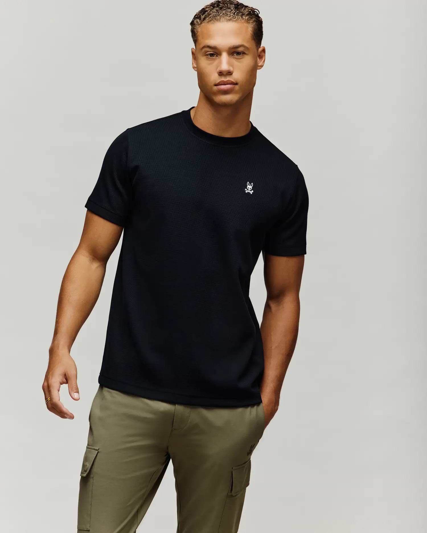Mens Maxton Waffle Tee, a black classic fit waffle knit t-shirt featuring a small, white embroidered Psycho Bunny skull logo on the left chest.