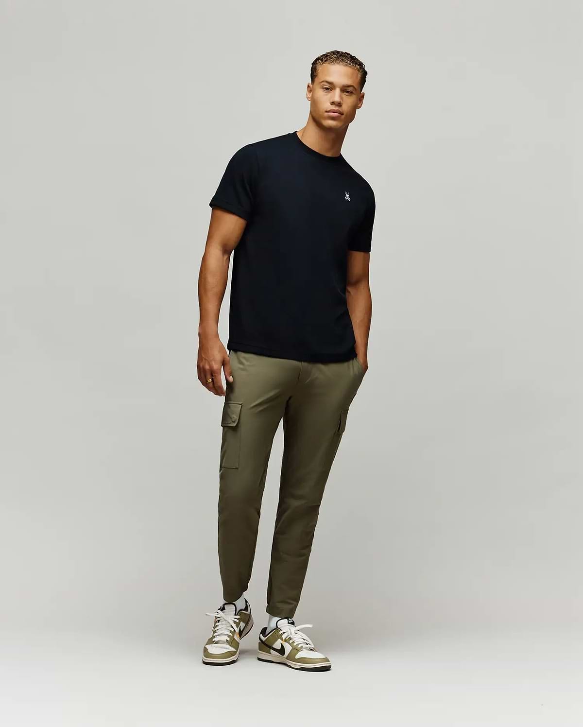 Black Mens Maxton Waffle Tee, a premium classic fit garment, showcasing the iconic small embroidered white and light blue Psycho Bunny skull logo on the left chest.