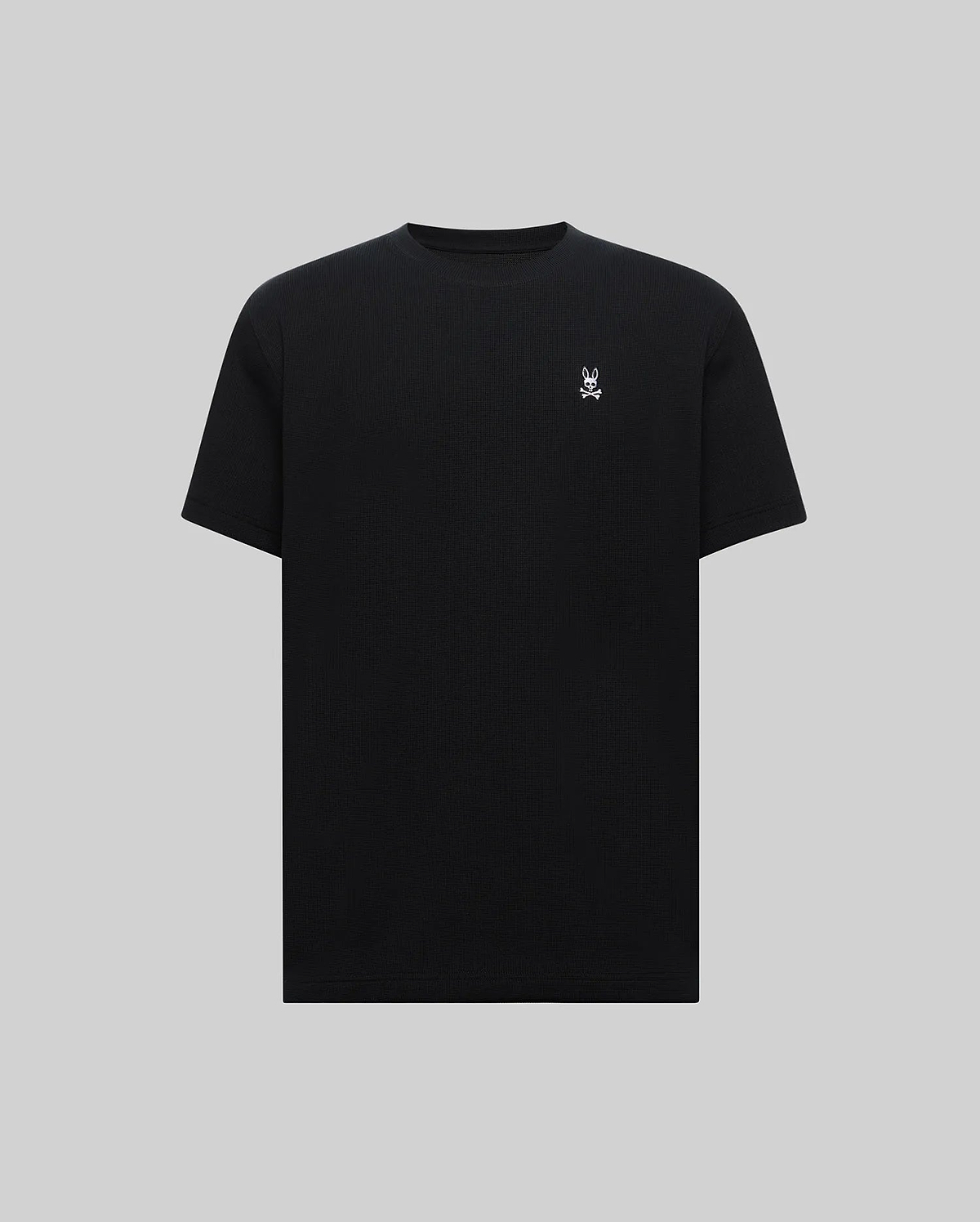 Mens Maxton Waffle Tee, a premium classic fit black waffle knit t-shirt featuring a small, crisp white embroidered Psycho Bunny skull logo on the left chest.
