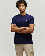 Mens Maxton Waffle Tee, a navy blue classic fit t-shirt with a waffle knit texture, featuring a small, embroidered white Psycho Bunny skull logo on the left chest.