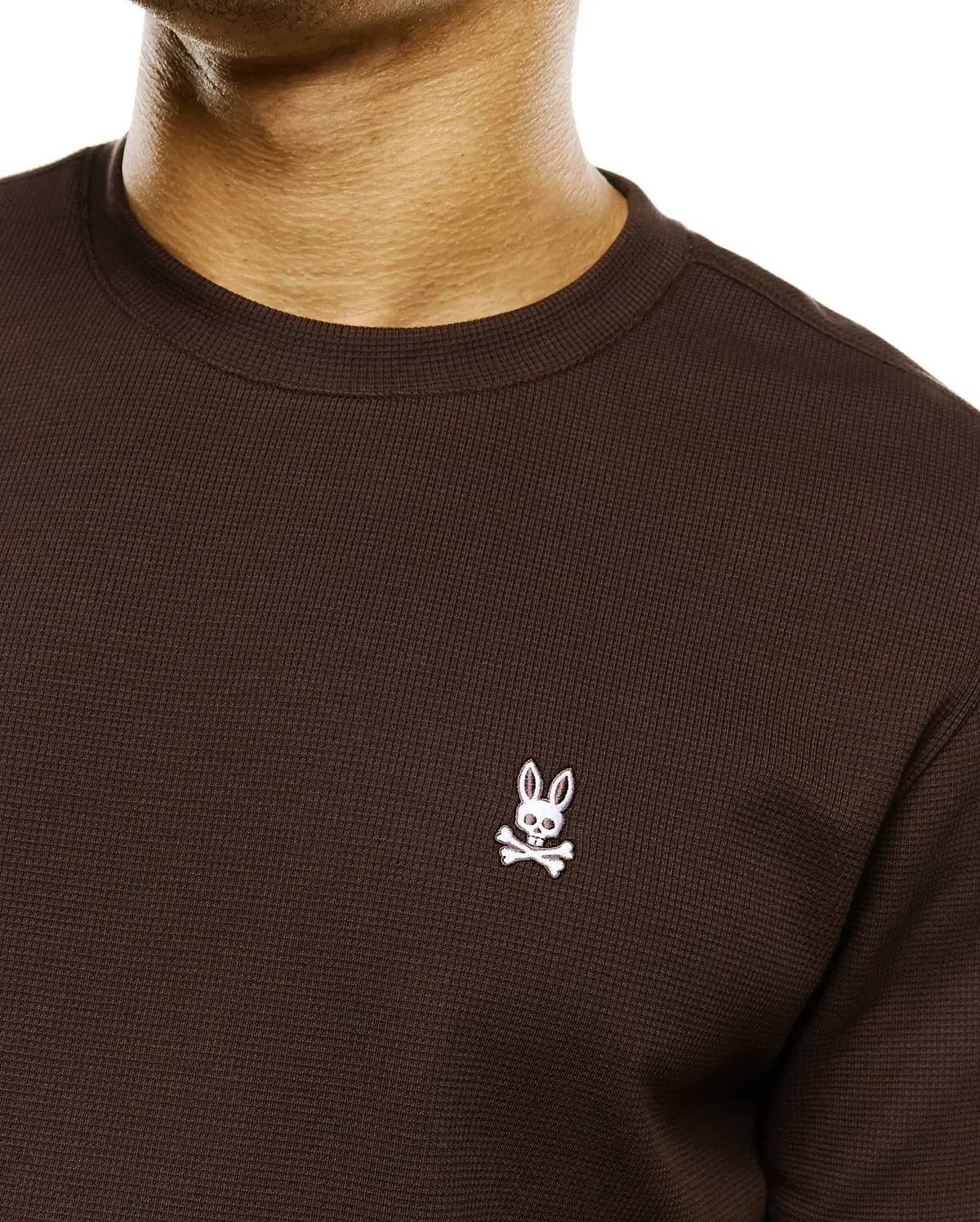 Men's Maxton Waffle Tee, a dark brown classic fit waffle knit long-sleeve t-shirt with a small white embroidered Psycho Bunny skull logo on the left chest. (2)