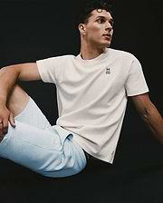 Mens Maxton Waffle Tee in cream, featuring a classic fit and textured waffle knit fabric, with a small embroidered black and white Psycho Bunny skull logo on the left chest.