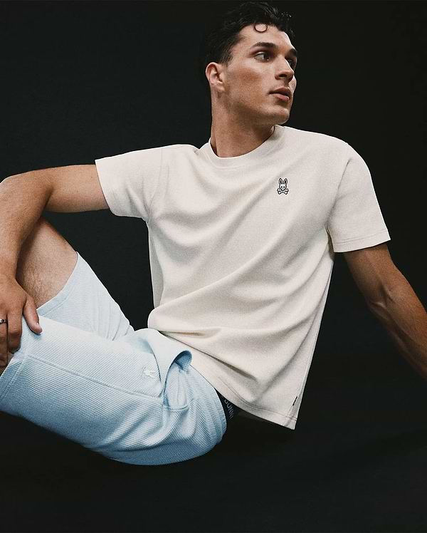 Mens Maxton Waffle Tee in cream, featuring a classic fit and textured waffle knit fabric, with a small embroidered black and white Psycho Bunny skull logo on the left chest.