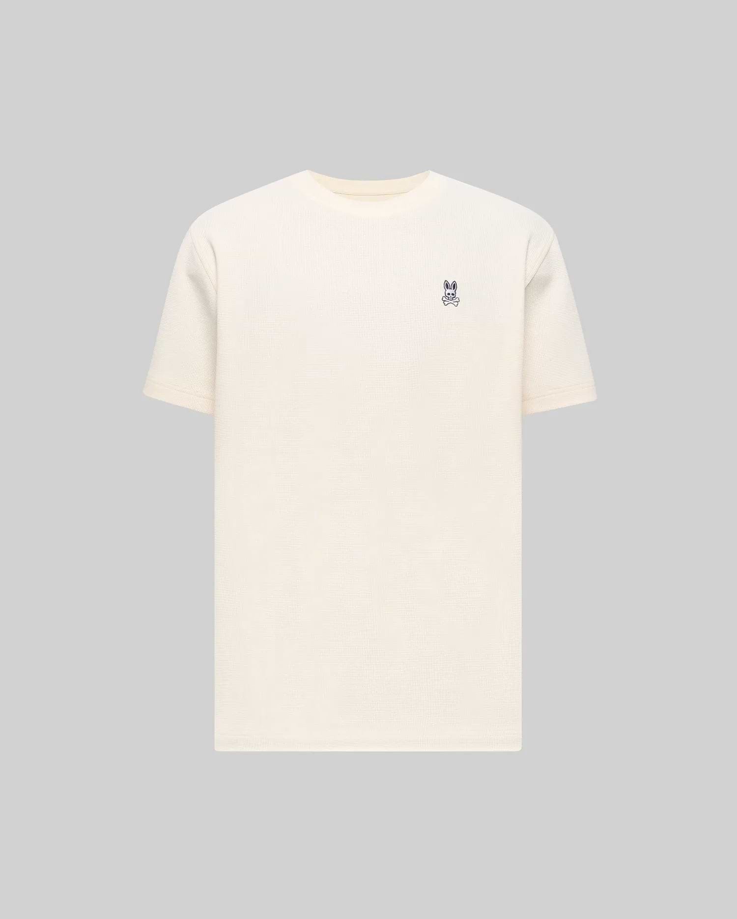 Mens Maxton Waffle Tee in cream, featuring a classic fit and textured waffle knit fabric, with a small embroidered dark blue Psycho Bunny skull logo on the left chest.