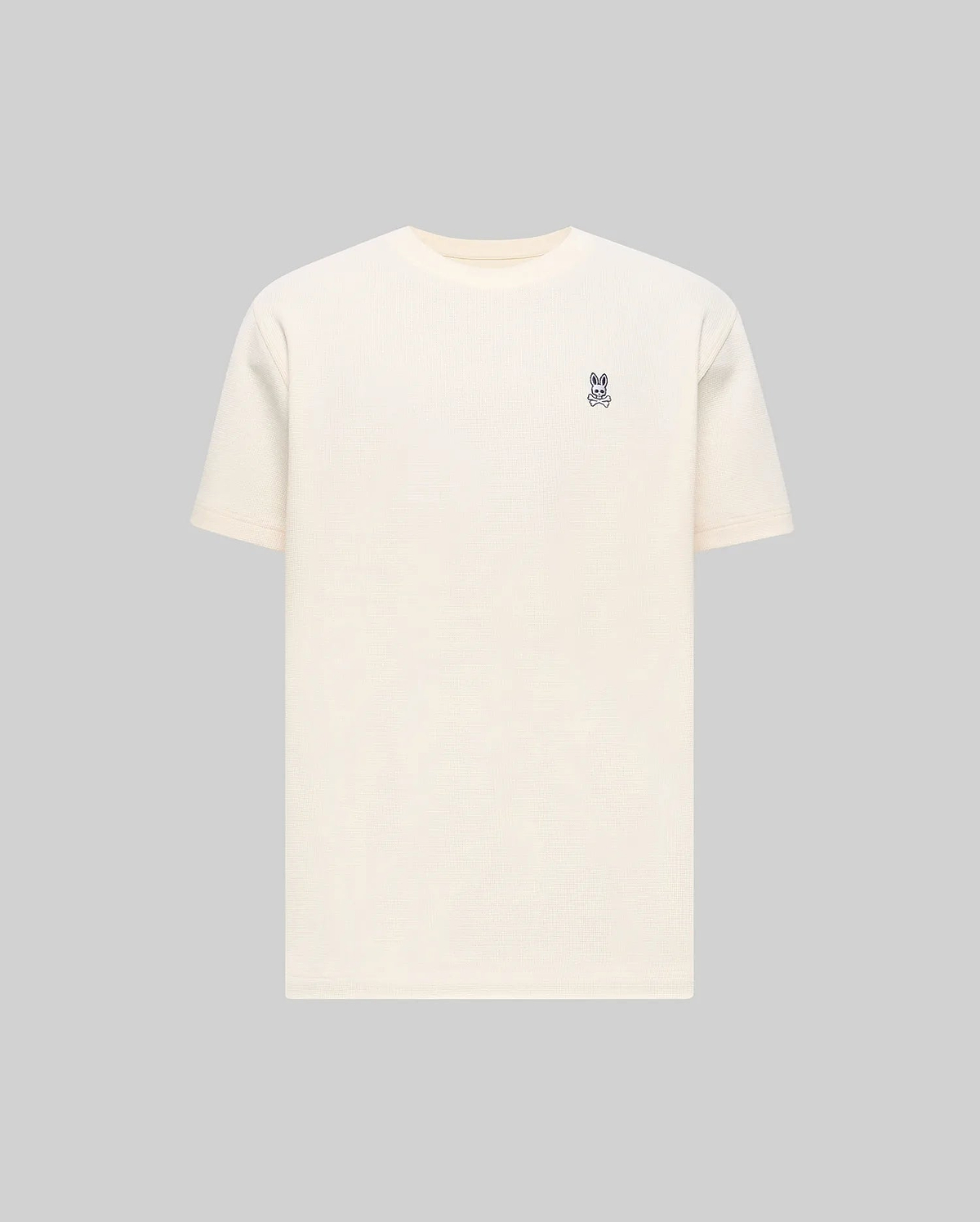 Mens Maxton Waffle Tee in cream, featuring a classic fit and textured waffle knit fabric, with a small embroidered dark blue Psycho Bunny skull logo on the left chest.