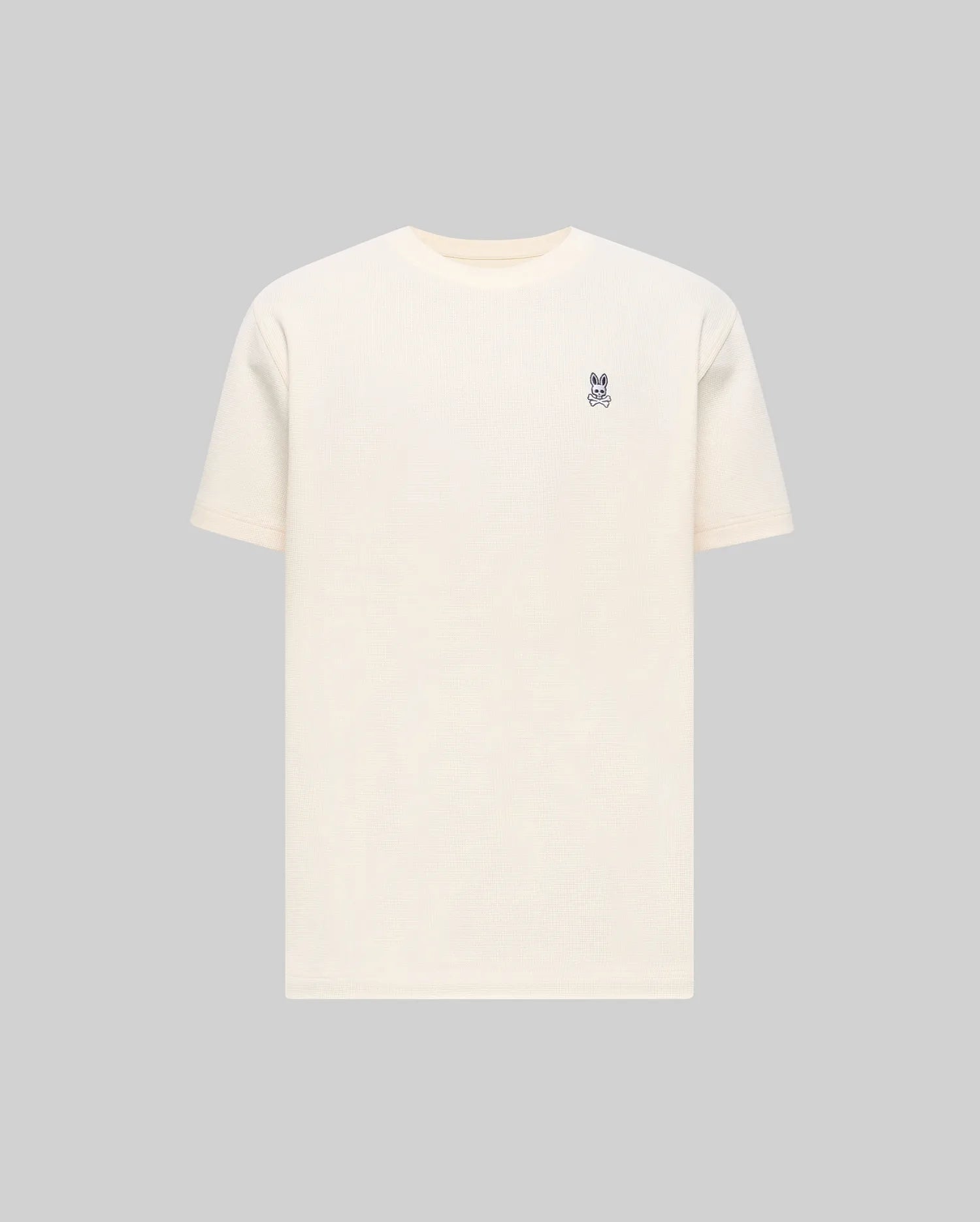 Mens Maxton Waffle Tee in cream, featuring a classic fit and textured waffle knit fabric, with a small embroidered dark blue Psycho Bunny skull logo on the left chest.