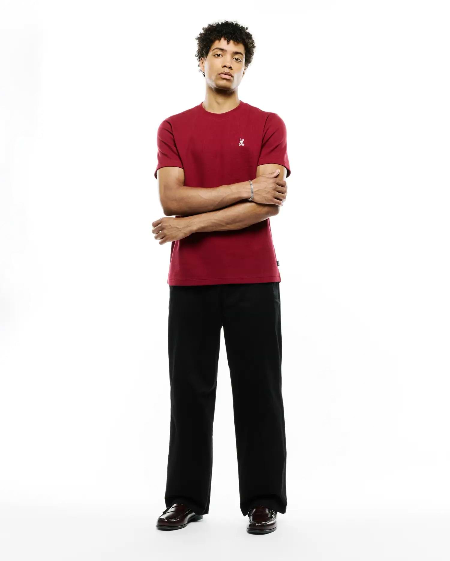 Mens Maxton Waffle Tee, a classic fit deep red t-shirt with a visible waffle knit texture and a small, embroidered white Psycho Bunny skull logo on the left chest.