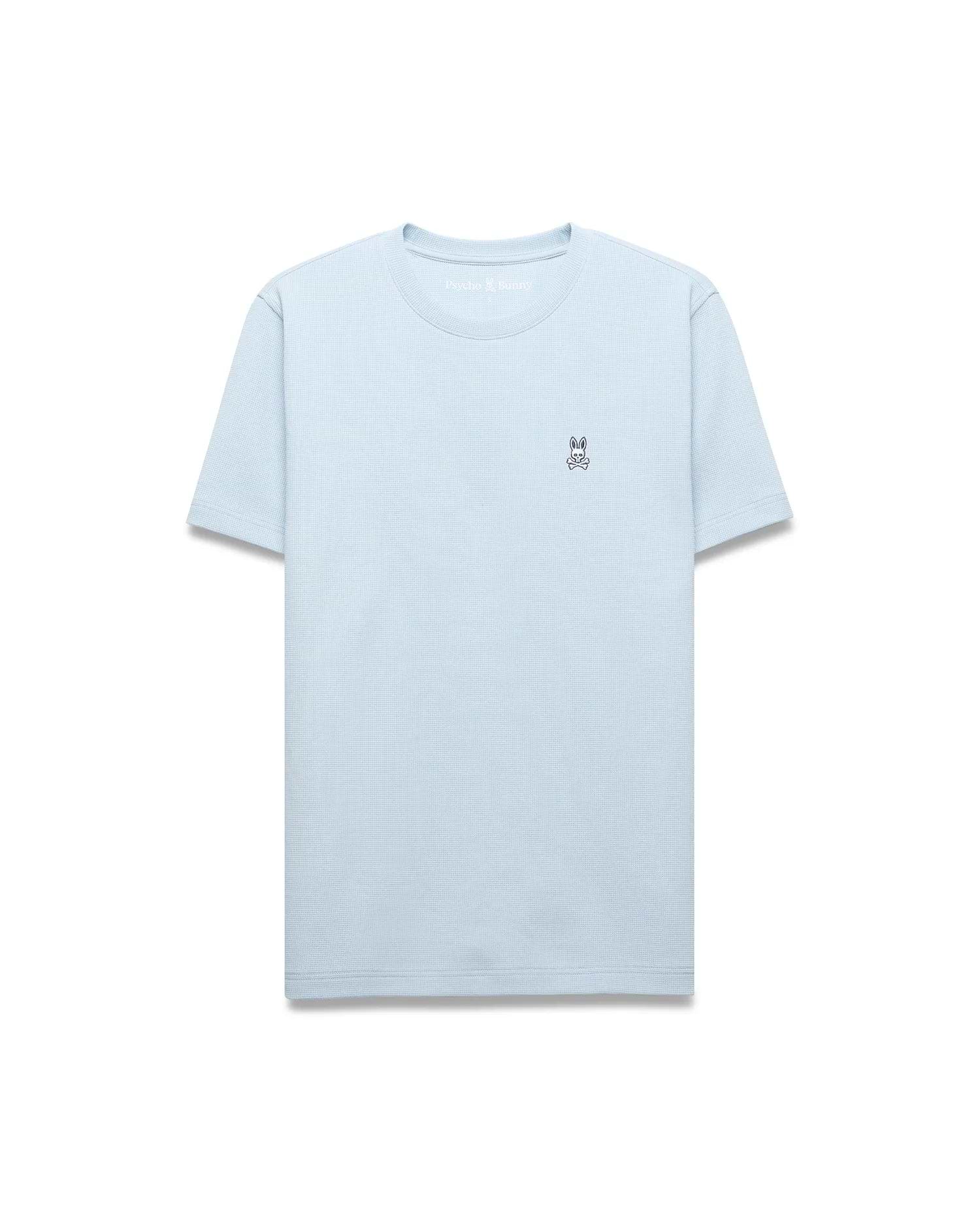 Light blue Mens Maxton Waffle Tee with a classic fit, featuring a subtle waffle knit texture and a small embroidered black and white Psycho Bunny skull logo on the left chest.