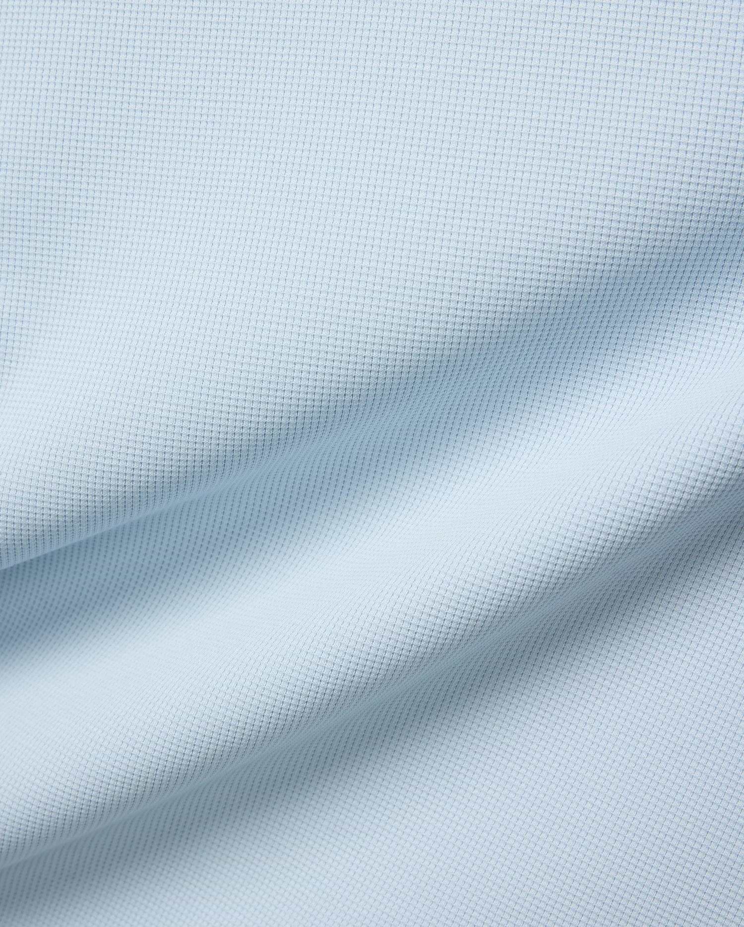 Mens Maxton Waffle Tee in soft light blue, crafted from a comfortable waffle knit fabric, featuring the iconic small embroidered Psycho Bunny skull logo on the left chest.