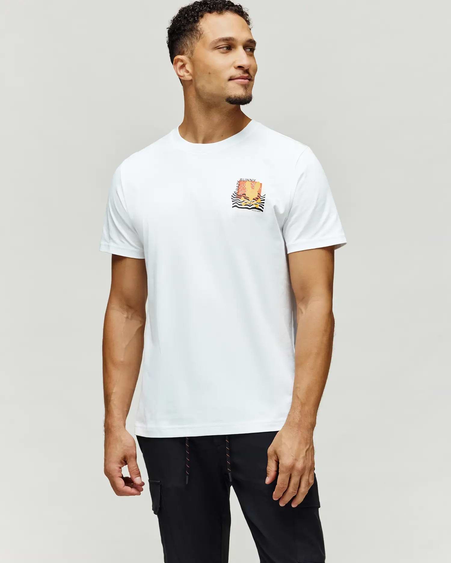 Mens Crazy Bunny Graphic Tee, a classic fit white jersey knit t-shirt with a small, colorful orange, yellow, and black graphic on the left chest, featuring CRAZY BUNNY text and wavy lines.