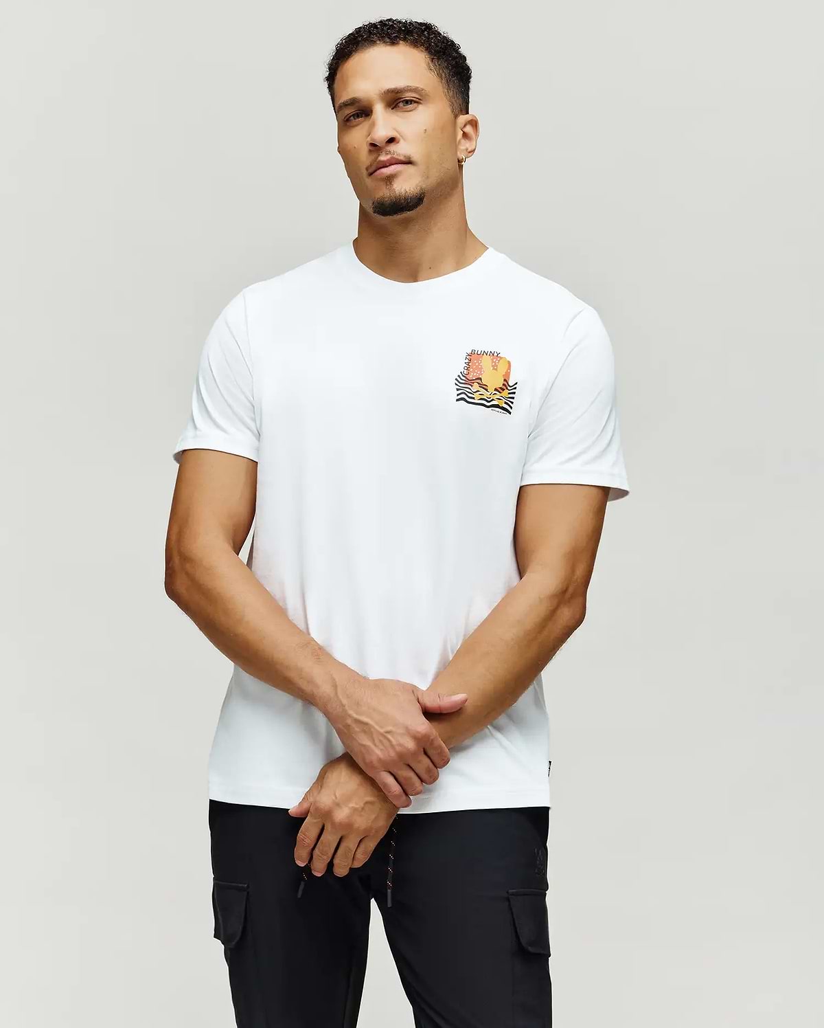 Mens Crazy Bunny Graphic Tee, a white classic fit jersey knit t-shirt featuring a vibrant orange and yellow sunset graphic with black waves and Crazy Bunny text on the left chest.