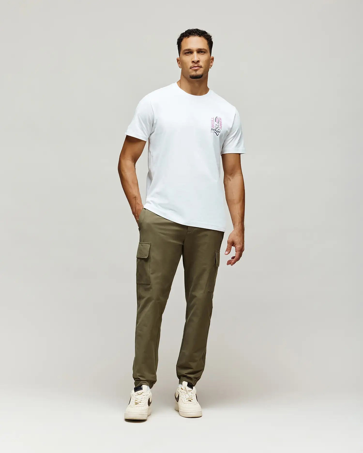 White Mens Skull Bunny Graphic Tee, classic fit, soft jersey fabric, featuring a vibrant pink and black stylized bunny skull graphic with vertical Skull Bunny text on the left chest.
