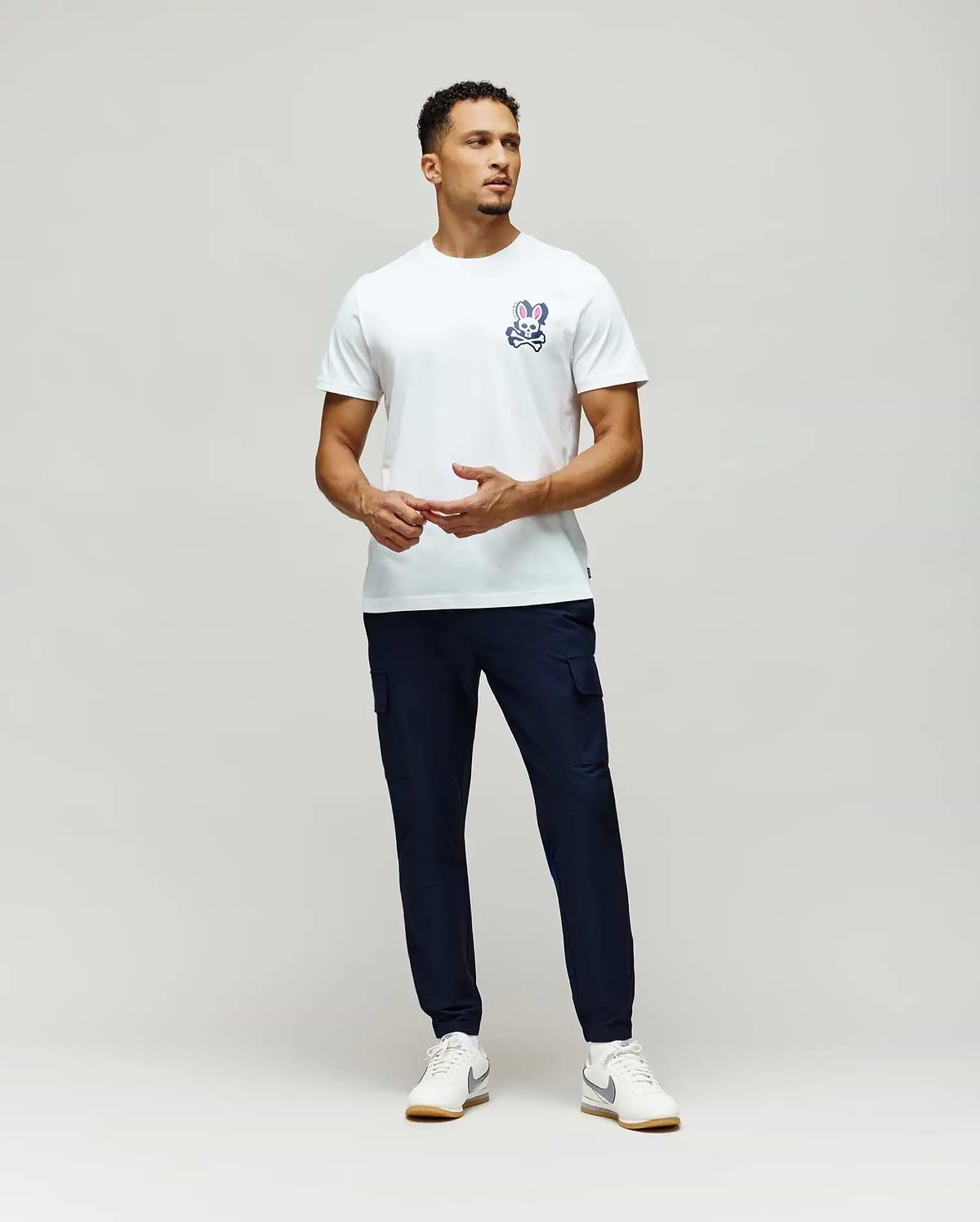Mens Psycho Skull Graphic Tee, a classic fit white jersey t-shirt featuring a small blue, white, and pink bunny skull logo on the left chest.