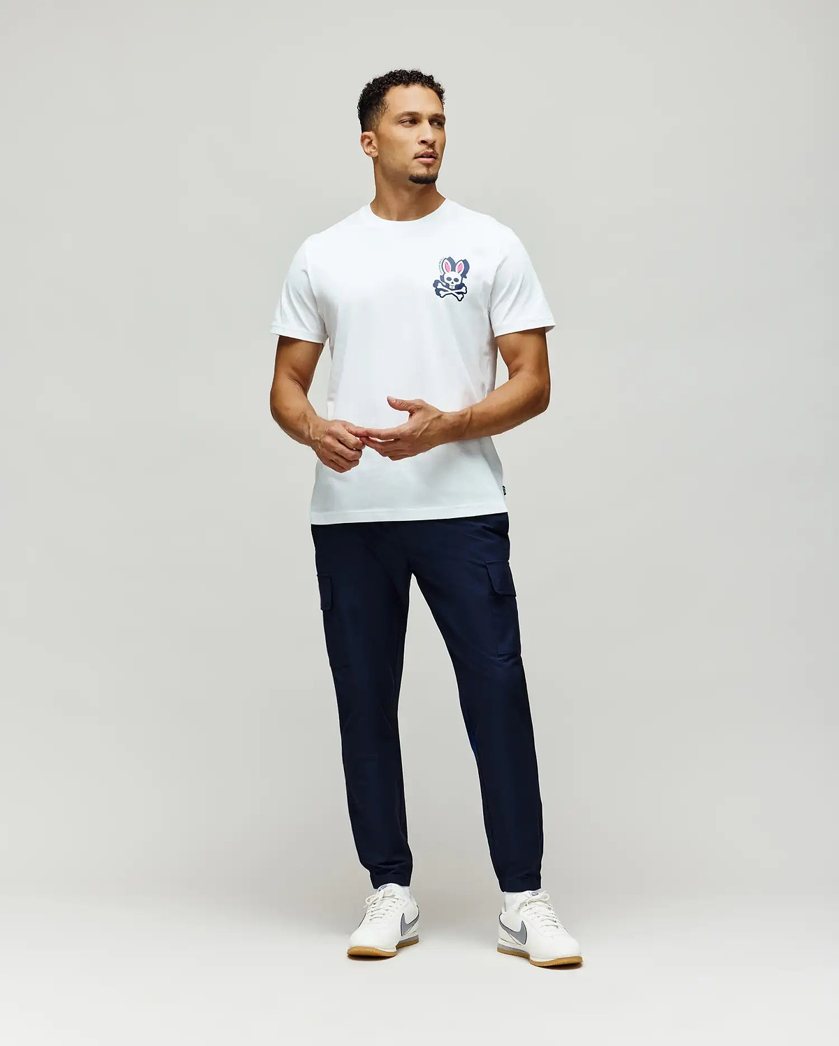 Mens Psycho Skull Graphic Tee, a classic fit white jersey t-shirt featuring a small blue, white, and pink bunny skull logo on the left chest.