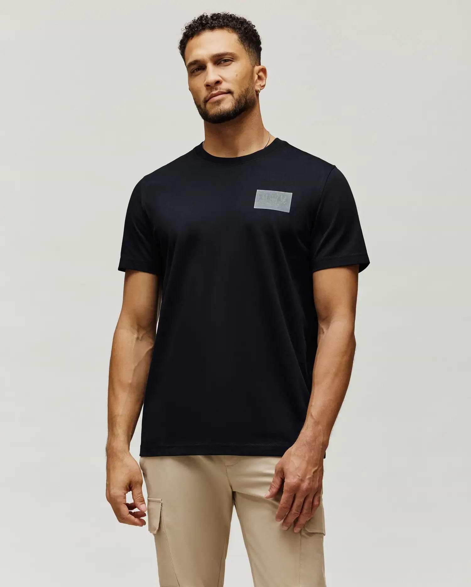 Mens Jarvis Chest Graphic Tee, a classic fit black jersey knit t-shirt with a subtle, tonal grey rectangular Psycho Bunny logo graphic on the left chest.