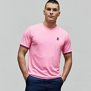 Mens Clark Performance Tee, a vibrant pink classic fit jersey t-shirt featuring a small embroidered magenta Psycho Bunny skull logo on the left chest and distinctive navy and pink striped ribbed sleeve cuffs.