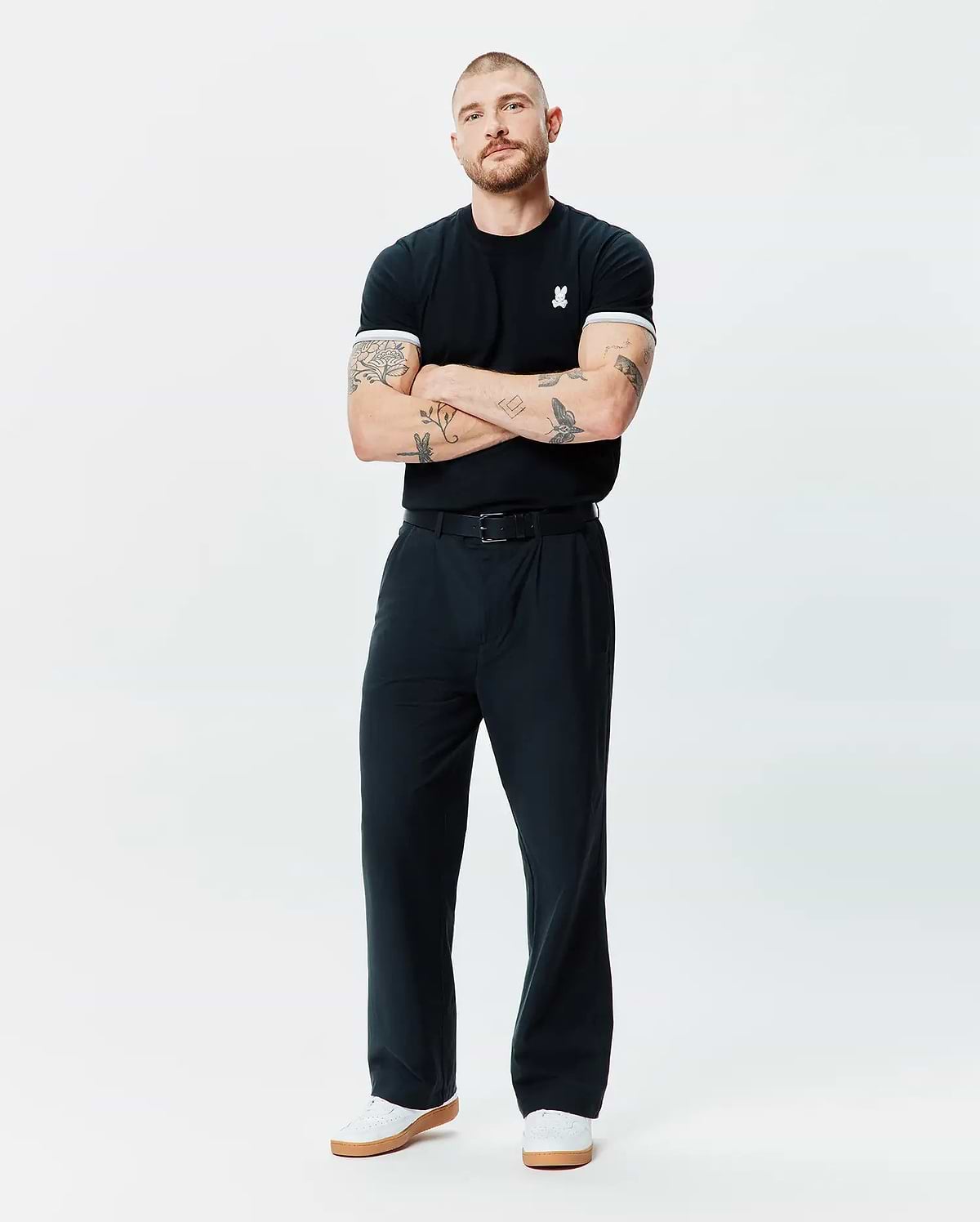 Black Mens Holden Tee in classic fit jersey knit, featuring a small white embroidered Psycho Bunny skull logo on the left chest and white ribbed cuffs.