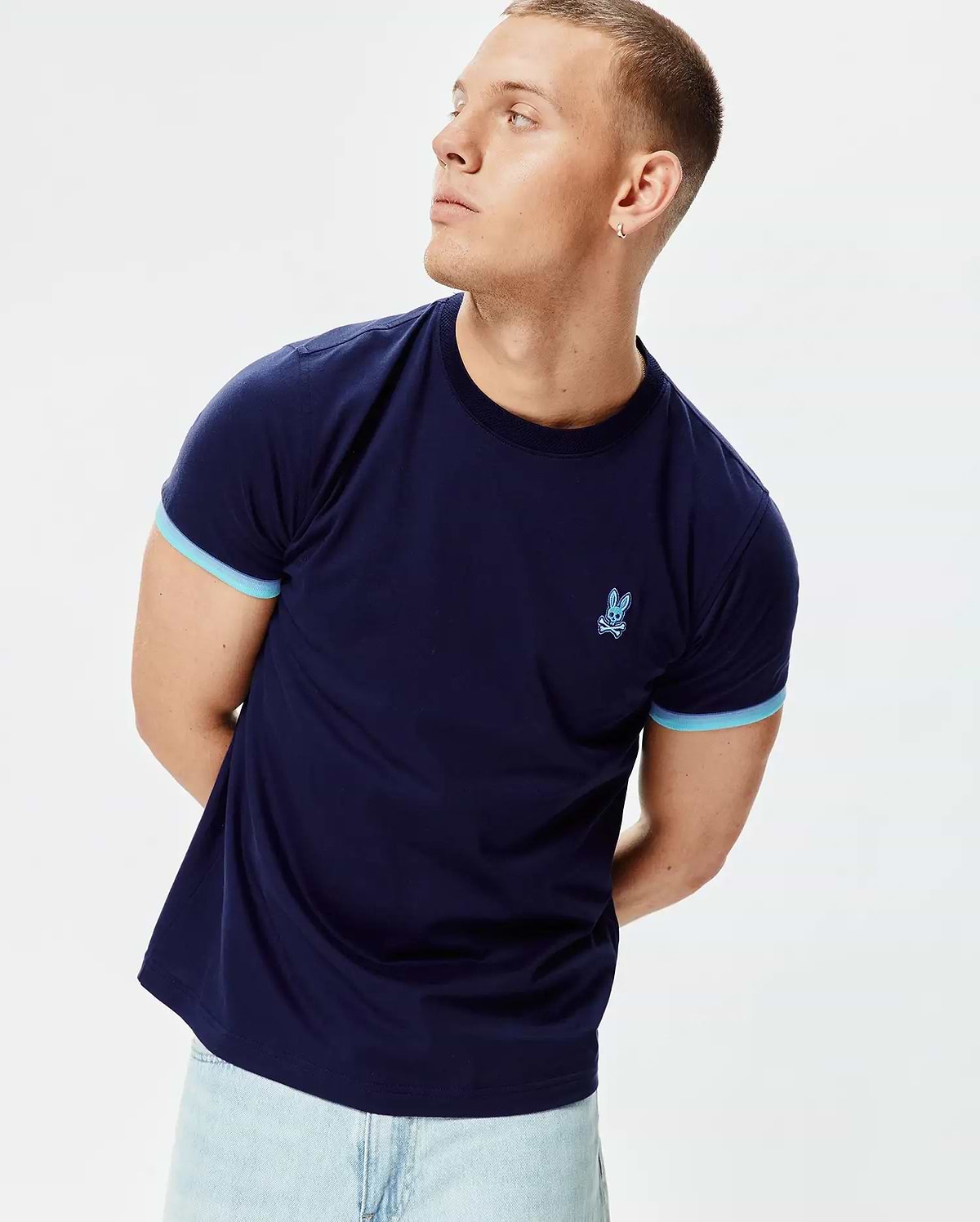 Mens Holden Tee, a classic fit navy blue jersey t-shirt with light blue contrast sleeve cuffs and an embroidered light blue Psycho Bunny skull logo on the left chest. (3)