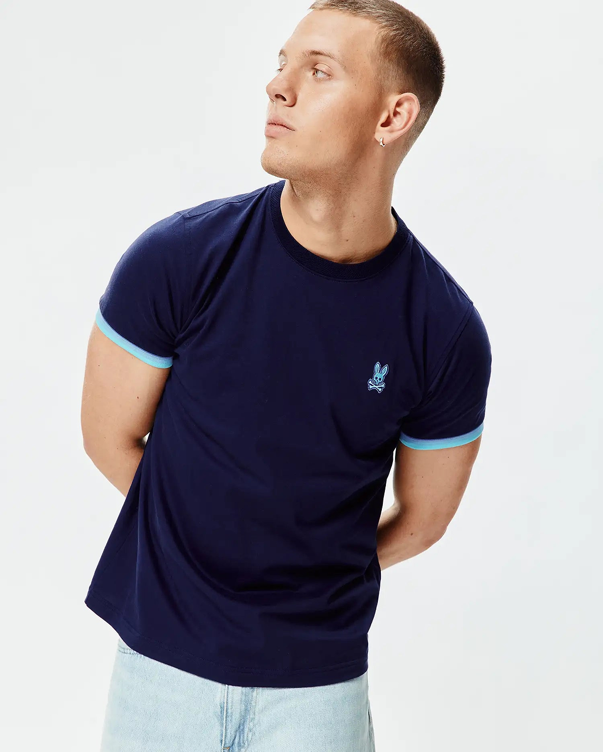 Mens Holden Tee, a classic fit navy blue jersey t-shirt with light blue contrast sleeve cuffs and an embroidered light blue Psycho Bunny skull logo on the left chest. (3)