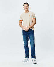Mens Holden Tee, a classic fit beige jersey t-shirt featuring a small embroidered orange Psycho Bunny skull logo on the left chest and orange double-striped cuffs.