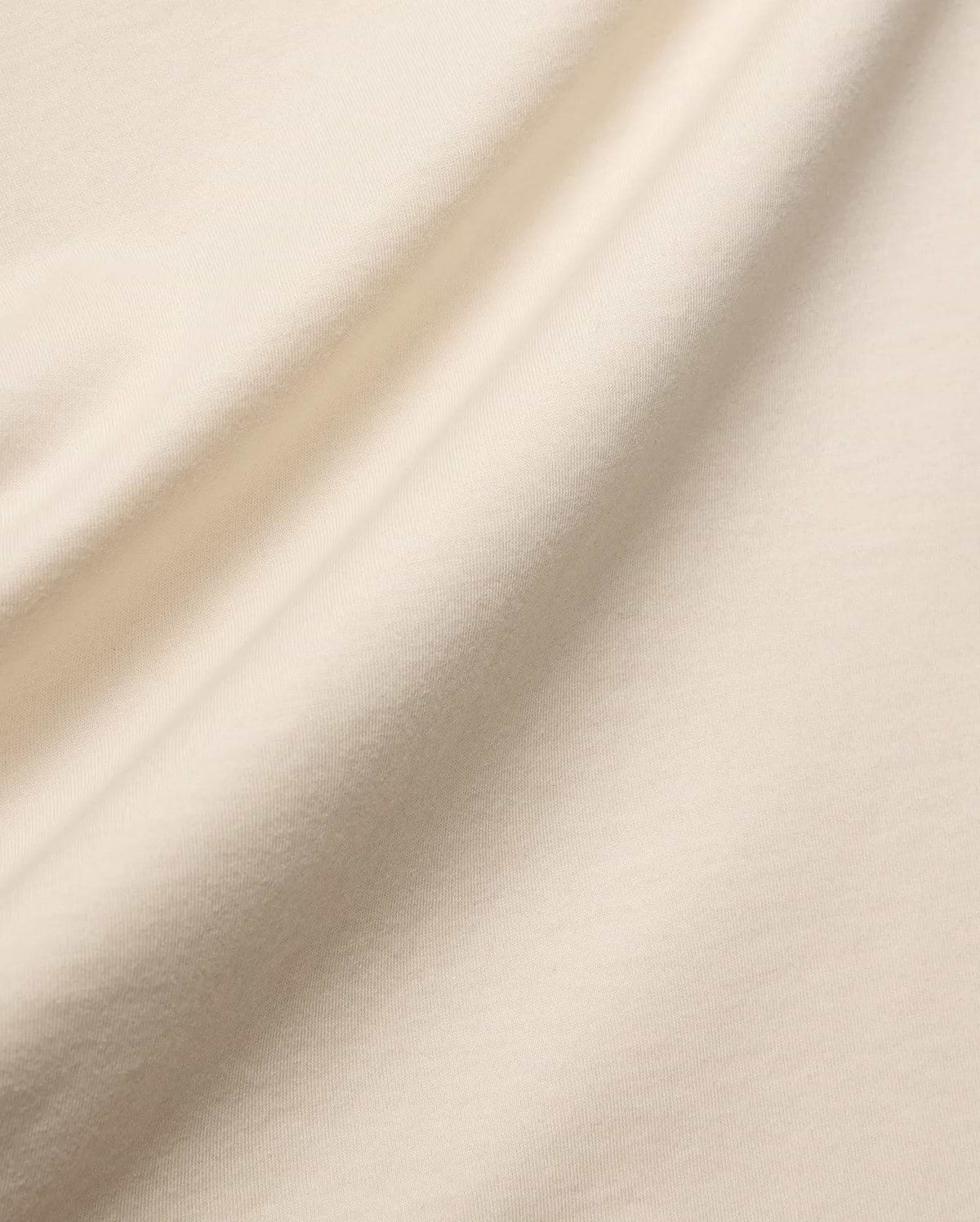 Mens Holden Tee, a premium quality t-shirt in a soft, light beige cotton jersey knit, featuring a smooth texture and elegant drape, characteristic of refined streetwear.