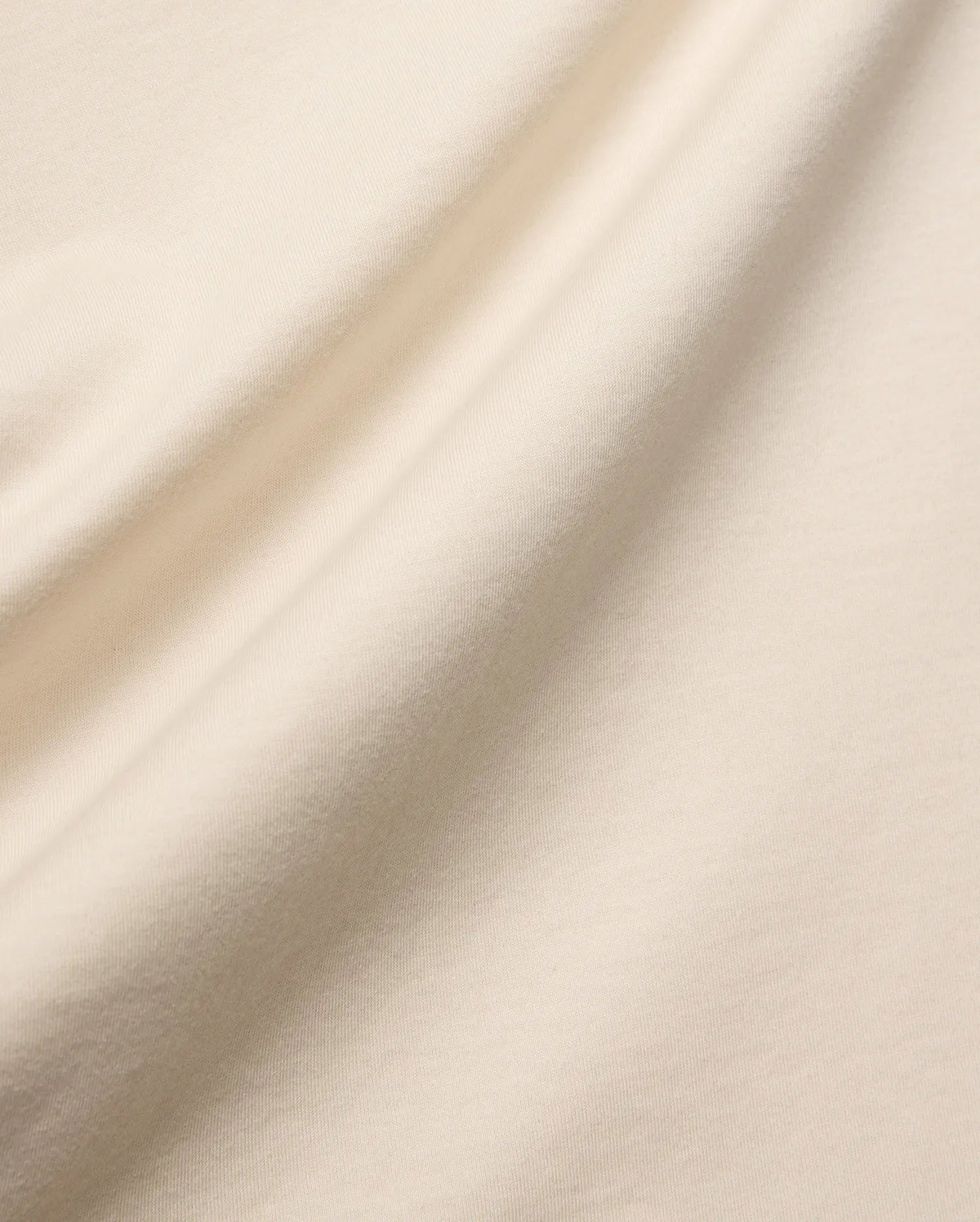 Mens Holden Tee, a premium quality t-shirt in a soft, light beige cotton jersey knit, featuring a smooth texture and elegant drape, characteristic of refined streetwear.