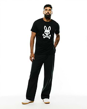 Mens Emmanuel Pima Cotton Graphic Tee, a black classic fit jersey t-shirt featuring a large white Psycho Bunny skull and crossbones graphic prominently centered on the chest.