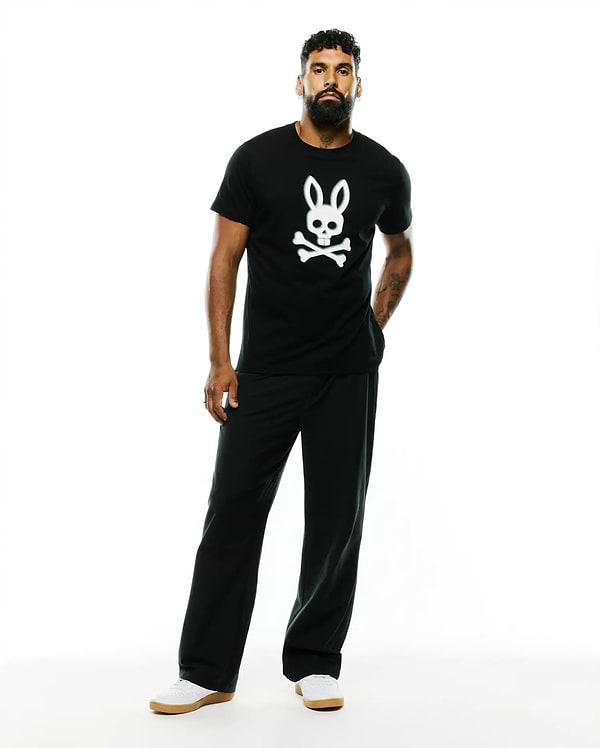 Mens Emmanuel Pima Cotton Graphic Tee, a black classic fit jersey t-shirt featuring a large white Psycho Bunny skull and crossbones graphic prominently centered on the chest.
