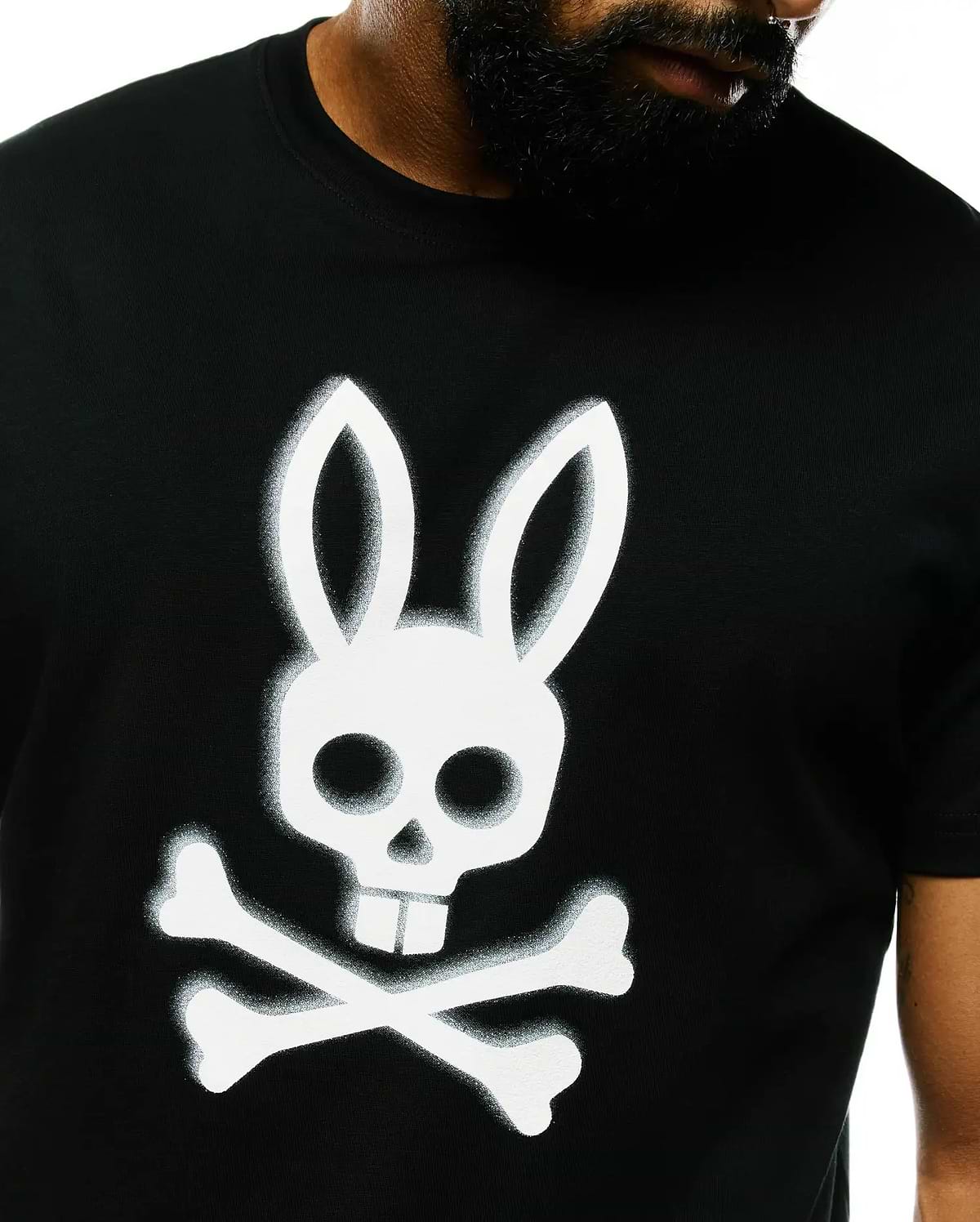 Mens Emmanuel Pima Cotton Graphic Tee, a classic fit black Pima cotton jersey t-shirt featuring a large, spray-painted white Psycho Bunny skull and crossbones graphic on the center chest.