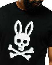 Mens Emmanuel Pima Cotton Graphic Tee, a classic fit black Pima cotton jersey t-shirt featuring a large, spray-painted white Psycho Bunny skull and crossbones graphic on the center chest.