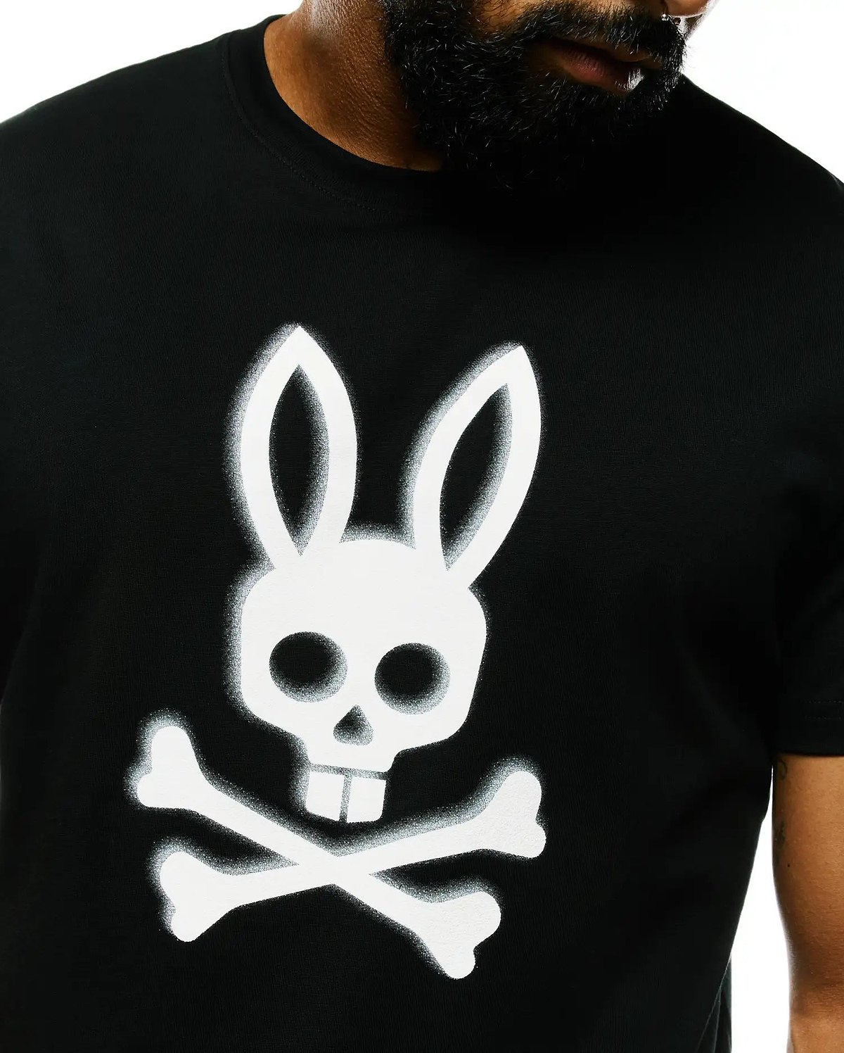 Mens Emmanuel Pima Cotton Graphic Tee, a classic fit black Pima cotton jersey t-shirt featuring a large, spray-painted white Psycho Bunny skull and crossbones graphic on the center chest.