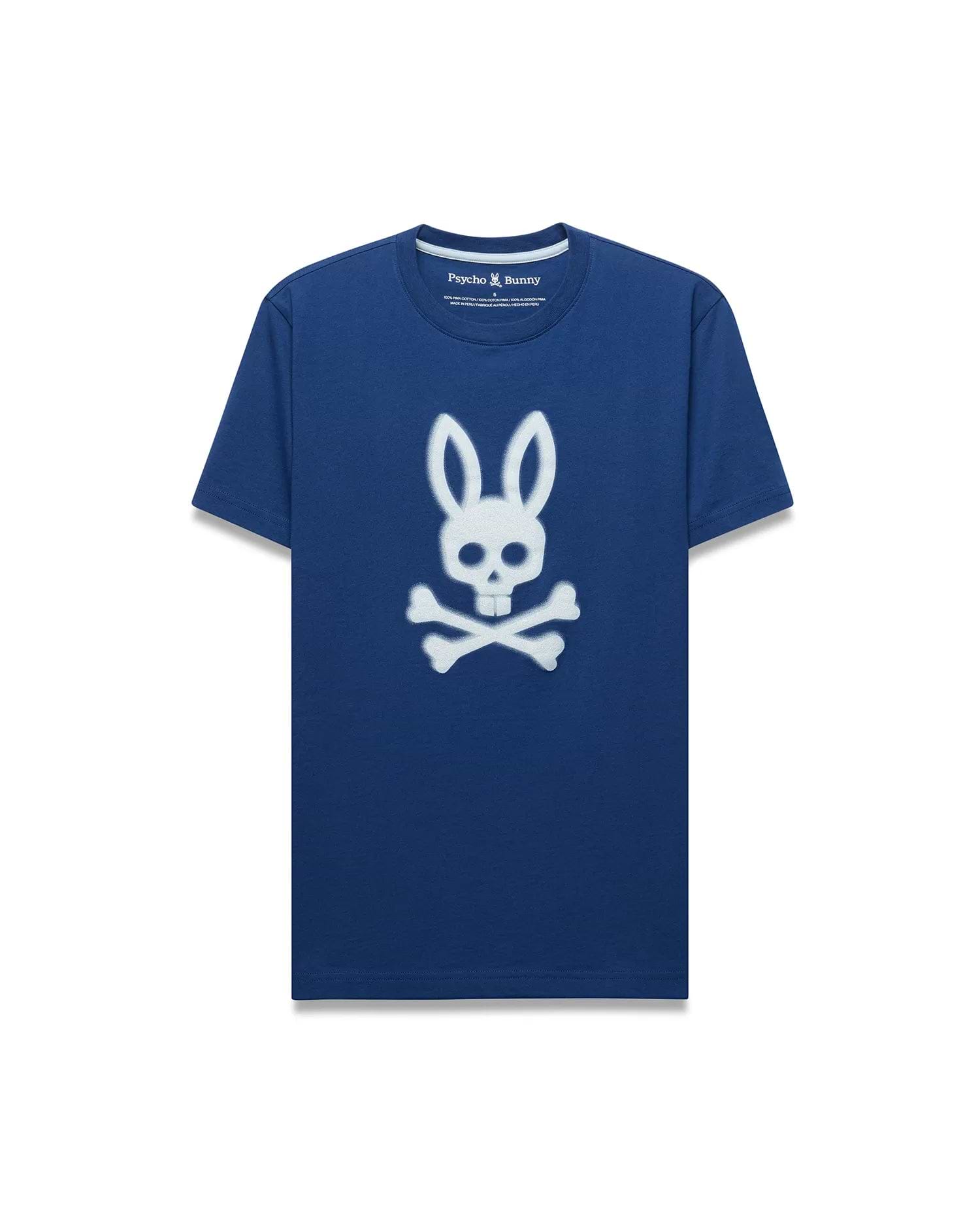 Mens Emmanuel Graphic Tee, a classic fit navy blue jersey t-shirt featuring a large, distressed white Psycho Bunny skull and crossbones graphic prominently on the chest.
