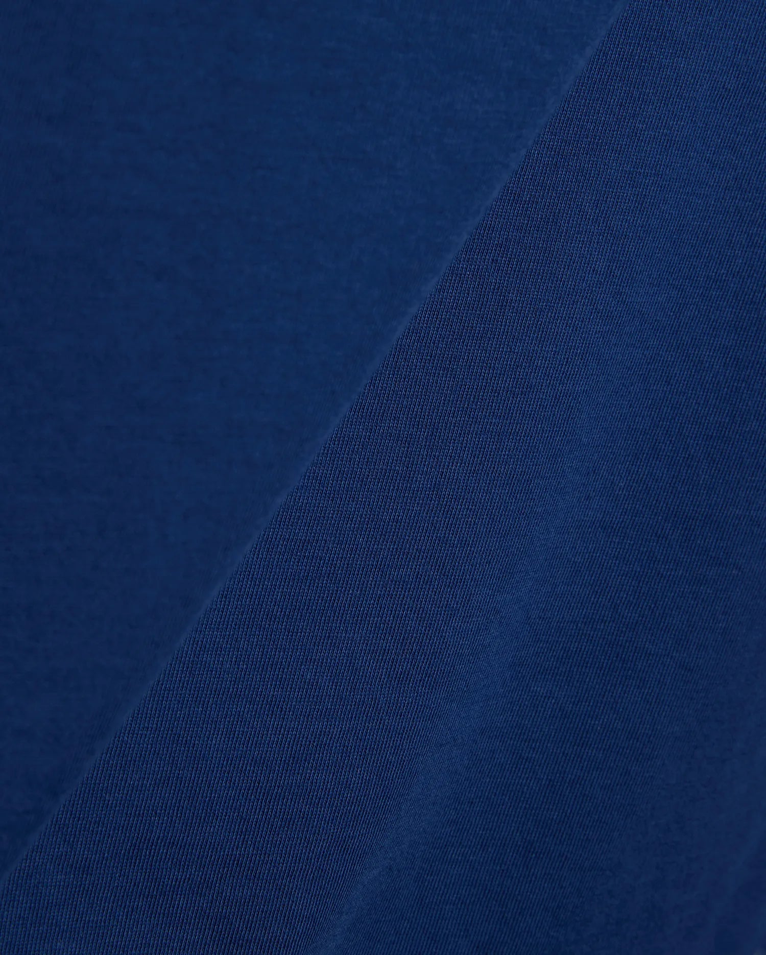 Mens Emmanuel Graphic Tee in rich navy blue, showcasing a soft, smooth jersey fabric on the main body, complemented by a finely textured, diagonal ribbed knit detail.