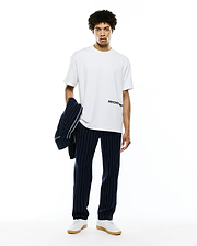 Mens Haiden Relaxed Heavy Weight Tee in crisp white, featuring a bold black Psycho Bunny wordmark logo printed horizontally on the left chest, made from premium heavy jersey fabric.
