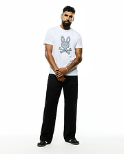 Mens Jaden Appliqué Graphic Tee, a white classic fit soft jersey t-shirt featuring a large center chest Psycho Bunny skull logo with a repeating bunny pattern and crossed bones.