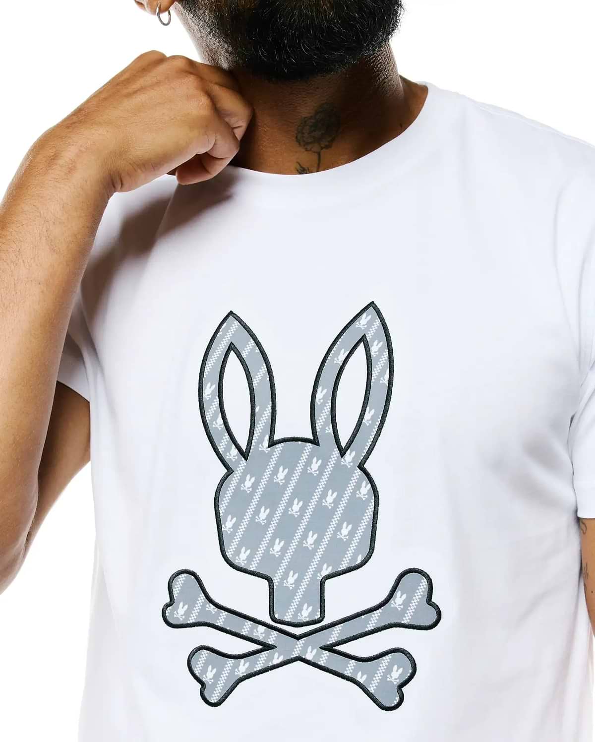 Mens Jaden Appliqué Graphic Tee, white classic fit jersey t-shirt with a large central gray bunny skull logo appliqué, outlined in black, featuring a diagonal stripe pattern and small white bunny skulls.