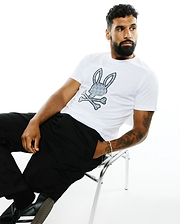 Mens Jaden Applique Graphic Tee, a classic fit white jersey t-shirt featuring a large grey and black Psycho Bunny skull and crossbones logo with a mini bunny skull pattern on the chest.