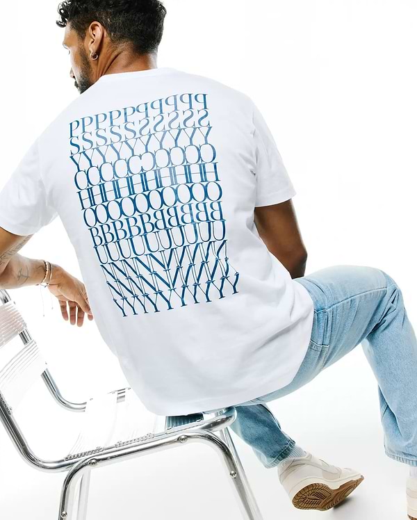 Mens Piers Pima Cotton Back Graphic Tee, a classic fit white jersey t-shirt featuring a large, bold blue stacked PSYCHO BUNNY text graphic covering the entire back.