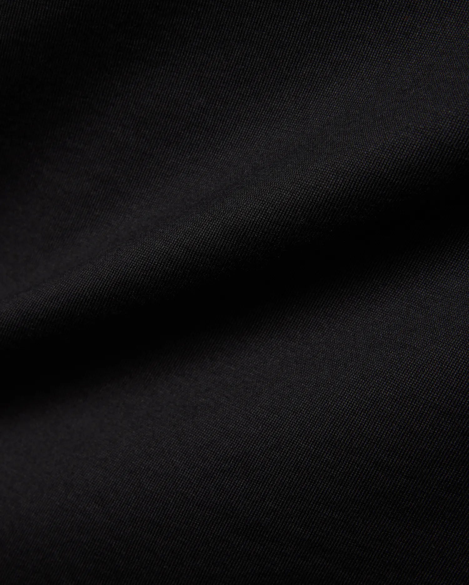 Mens Jaydon Wordmark Graphic Tee in classic black, crafted from soft jersey knit fabric with a subtle diagonal texture, featuring a bold wordmark graphic.