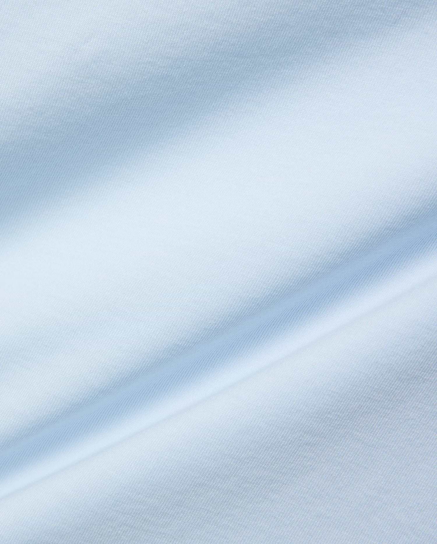 Mens Jaydon Wordmark Graphic Tee, a premium light blue jersey knit fabric with a smooth, soft texture and subtle, flowing folds, reflecting refined streetwear quality.